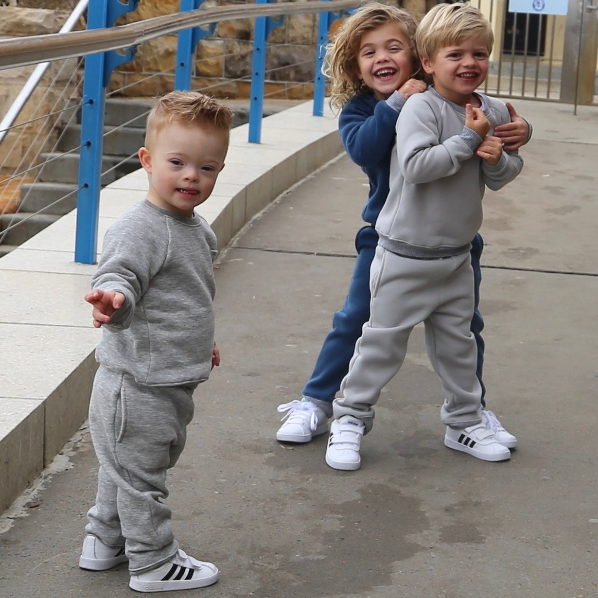 Toddler Boy wearing Grey Marle trackpant featuring Grey Marle waistband and hem cuffs, side pockets. Ethically made in Australia with cotton blend cosy and warm fleece