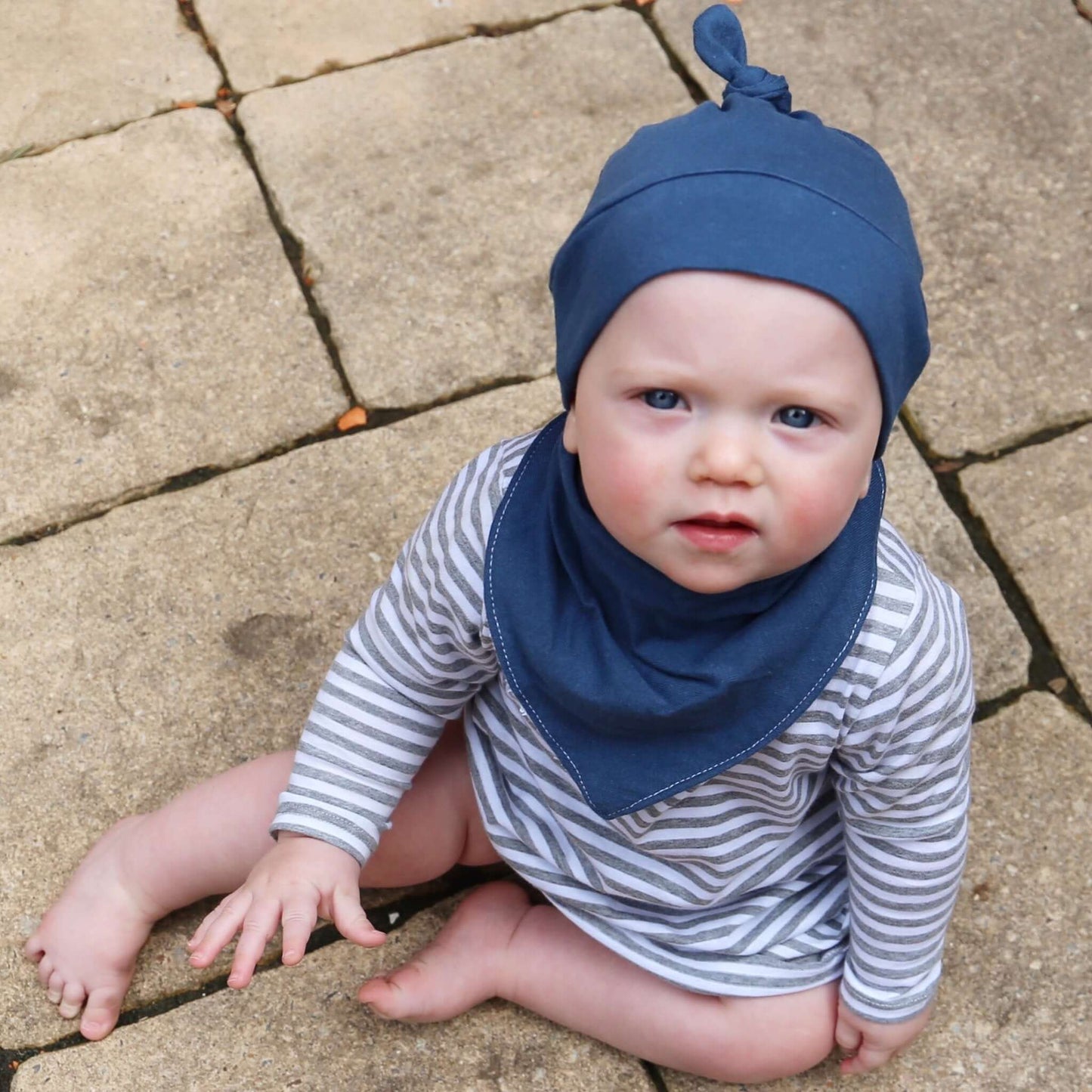 baby wearing blue dribble bib. ethically made in australia with 100% cotton jersey and terry towleling lining.