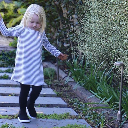 toddler girl wearing grey marle/white stripe long sleeve dress. Ethically made in australia with 100% cotton jersey