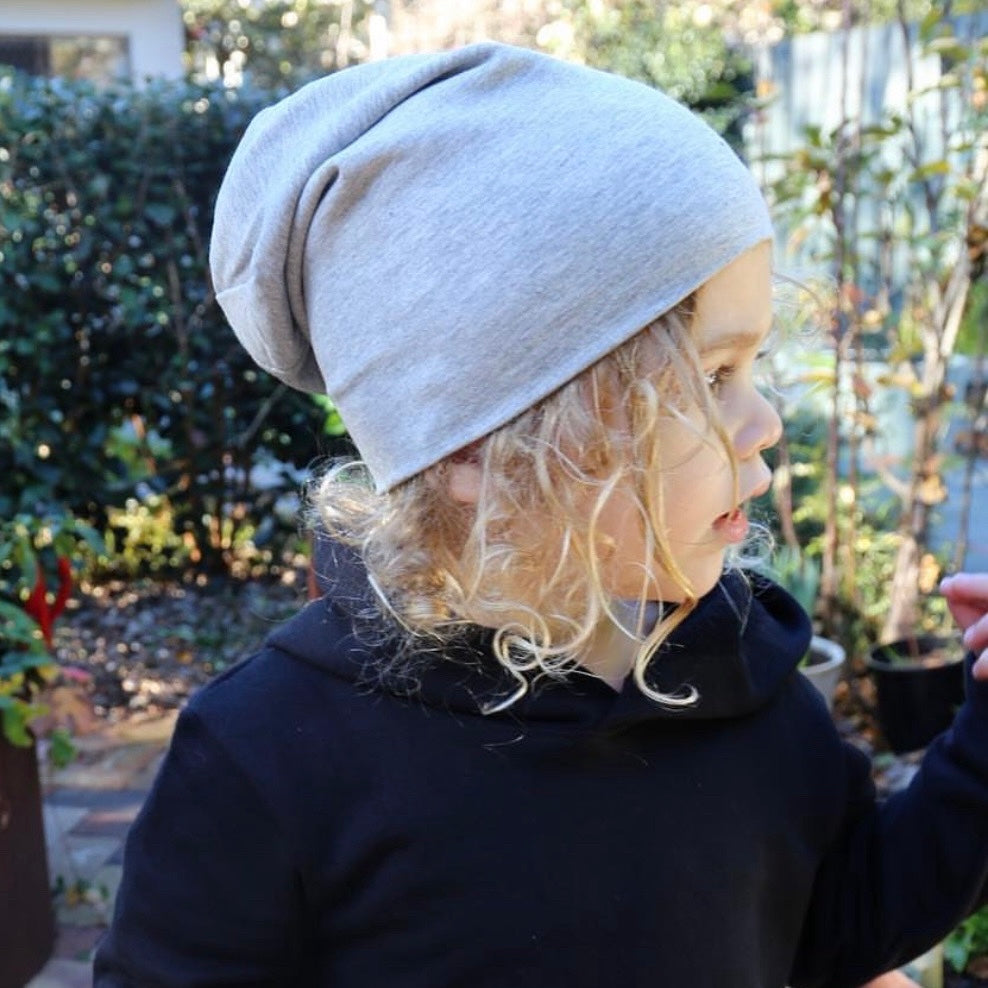 boy wearing grey marle slouchy beanie. Ethichally made in australia with stretch cotton ponte fabric