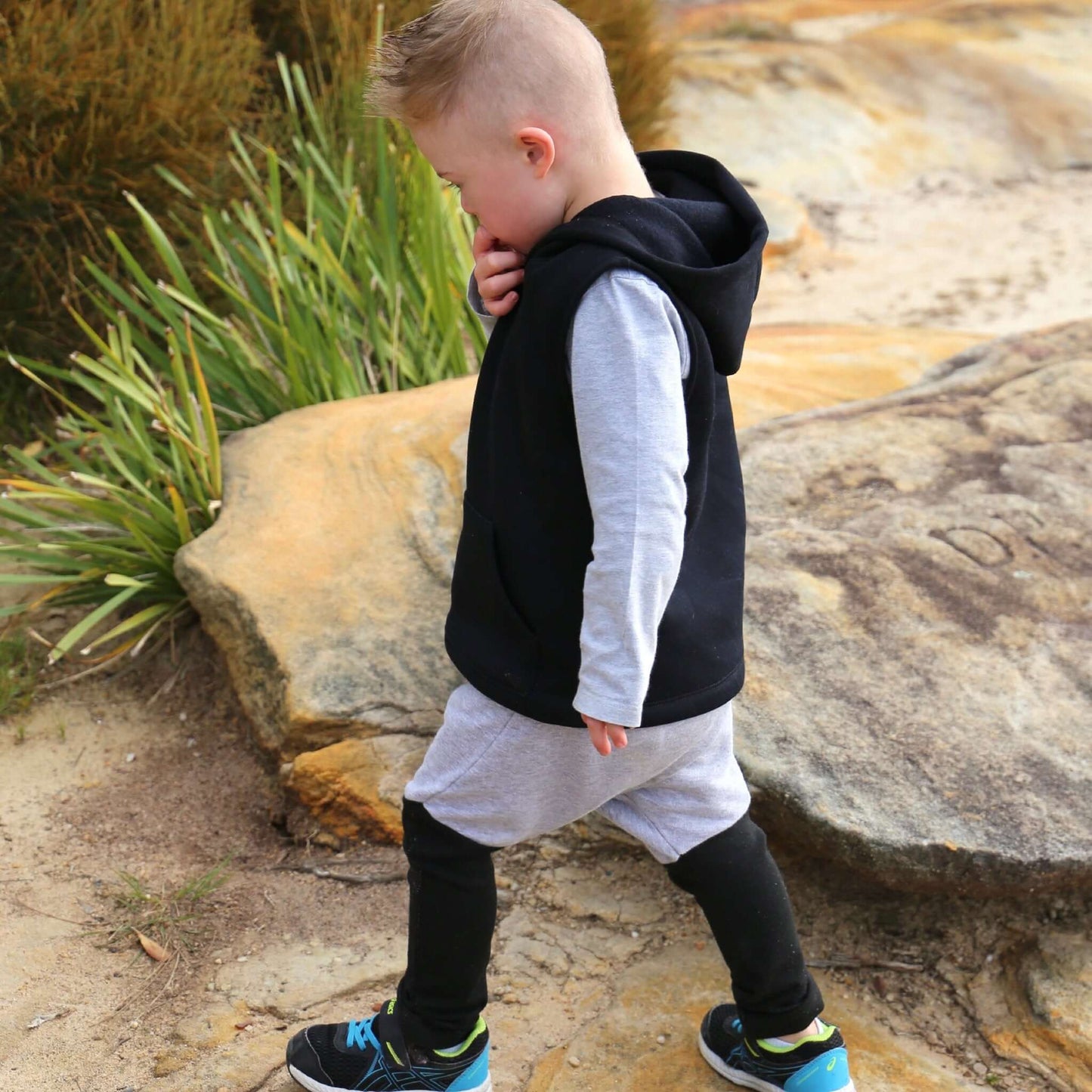 boy wearing grey marle with black contrast harem pant featuring an elastic waistband. Ethically made in australia with 100% cotton french terry and contrast ponte fabric