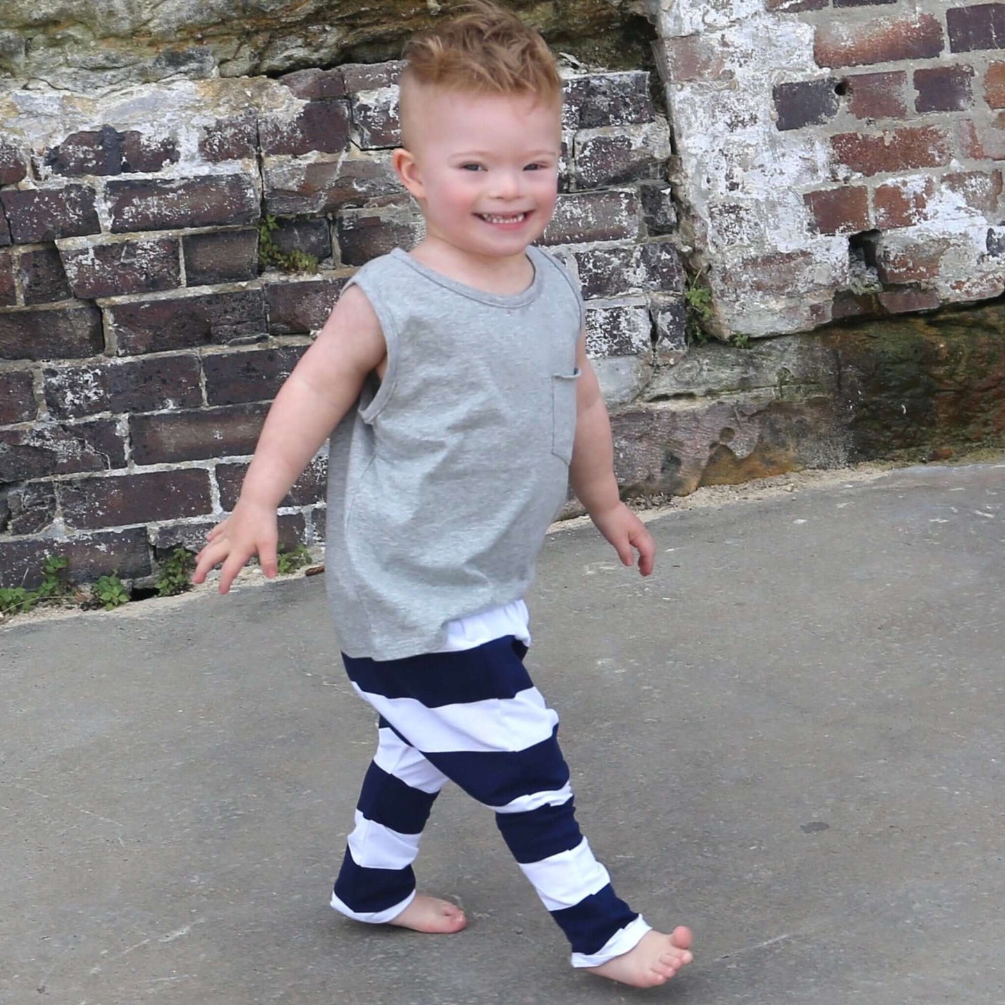 toddler boy wearing grey marle singlet with front pocket. Ethically made in australia with 100% cotton jersey