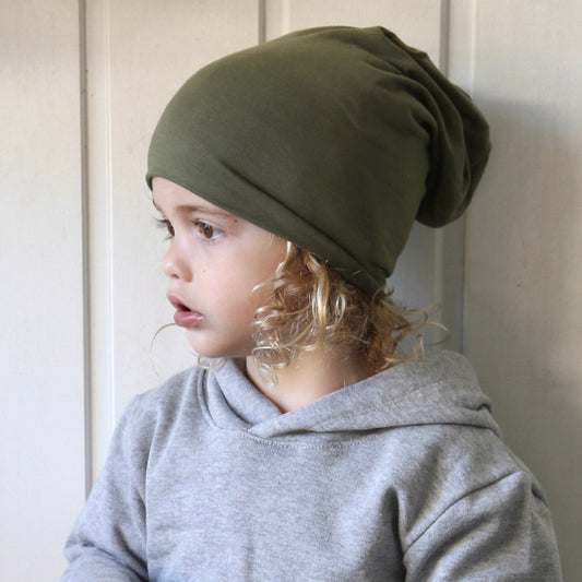 boy wearing khaki slouchy beanie. Ethichally made in australia with stretch cotton super soft jersey