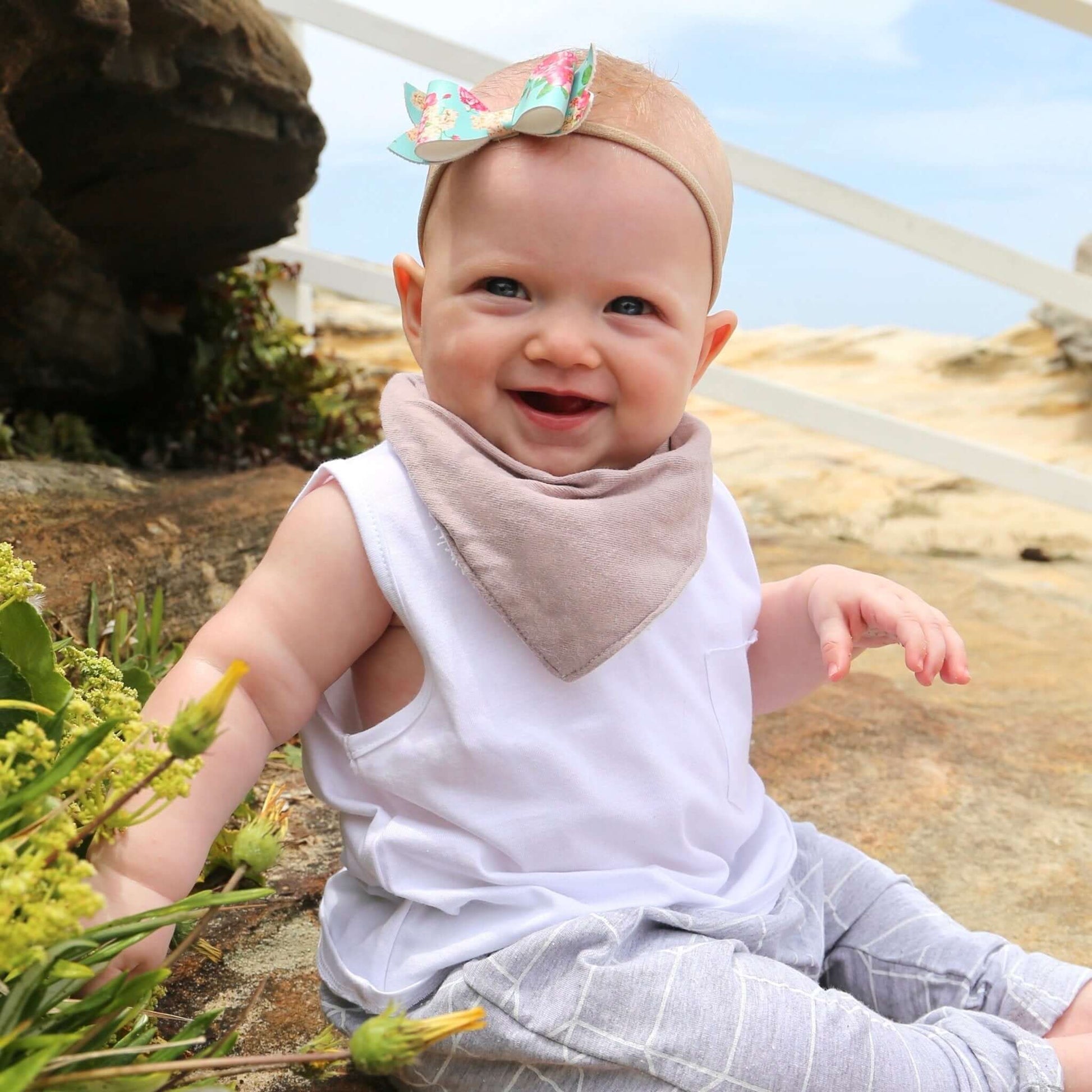 baby wearing musk colour dribble bib. ethically made in australia with 100% cotton jersey and terry towelling lining.