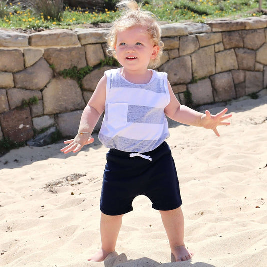 Toddler wearing Navy drop crotch shorts with white contrast drawcord and elastic waistband.  Ethically made in Australia with a 100% cotton soft stretch jersey fabric