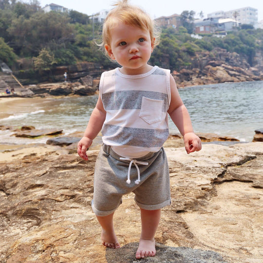 toddler girl wearing navy/white stripe singlet with front pocket. Ethically made in australia with 100% cotton jersey