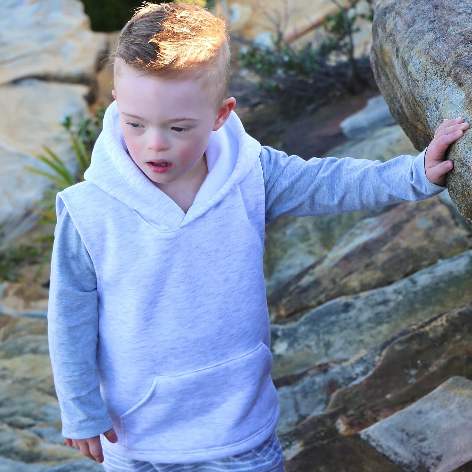 Boy wearing White Marle Sleeveless Hoodie ethically made in Australia with a Cotton blend soft cosy Fleece