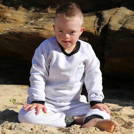 Boy wearing White Marle Winter Sweater featuring Black contrast rib at neck, hem and cuff with front pocket ethically made in Australia with Cotton blend cosy and warm Fleece