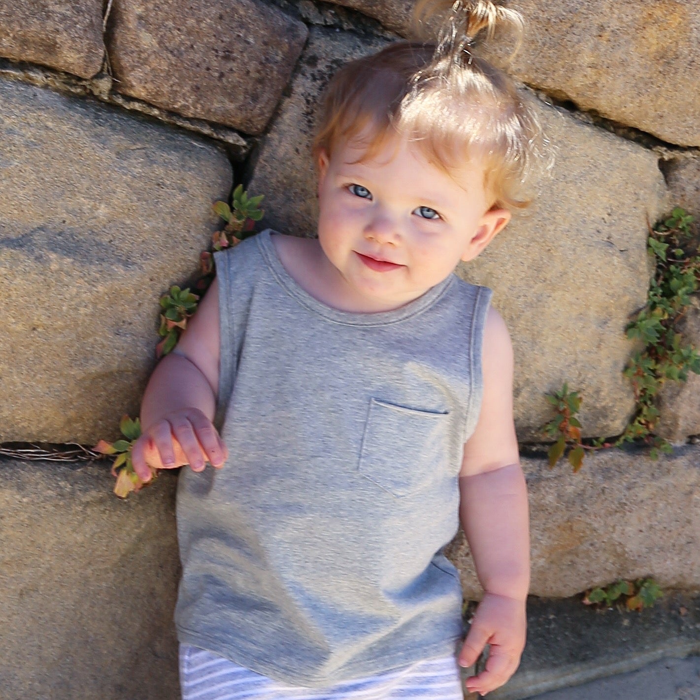 toddler girl wearing grey marle singlet with front pocket. Ethically made in australia with 100% cotton jersey