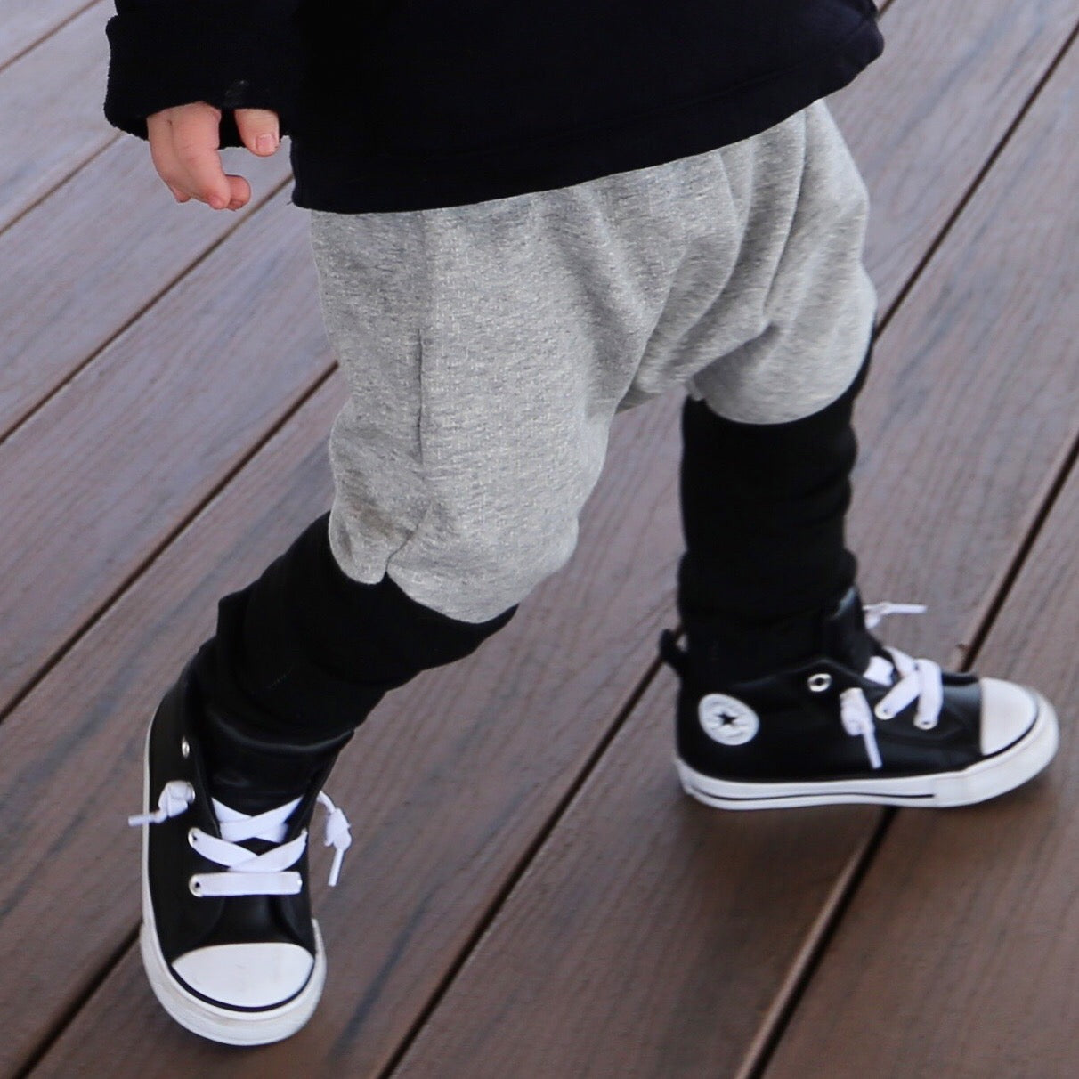 boy wearing grey marle with black contrast harem pant featuring an elastic waistband. Ethically made in australia with 100% cotton french terry and contrast ponte fabric